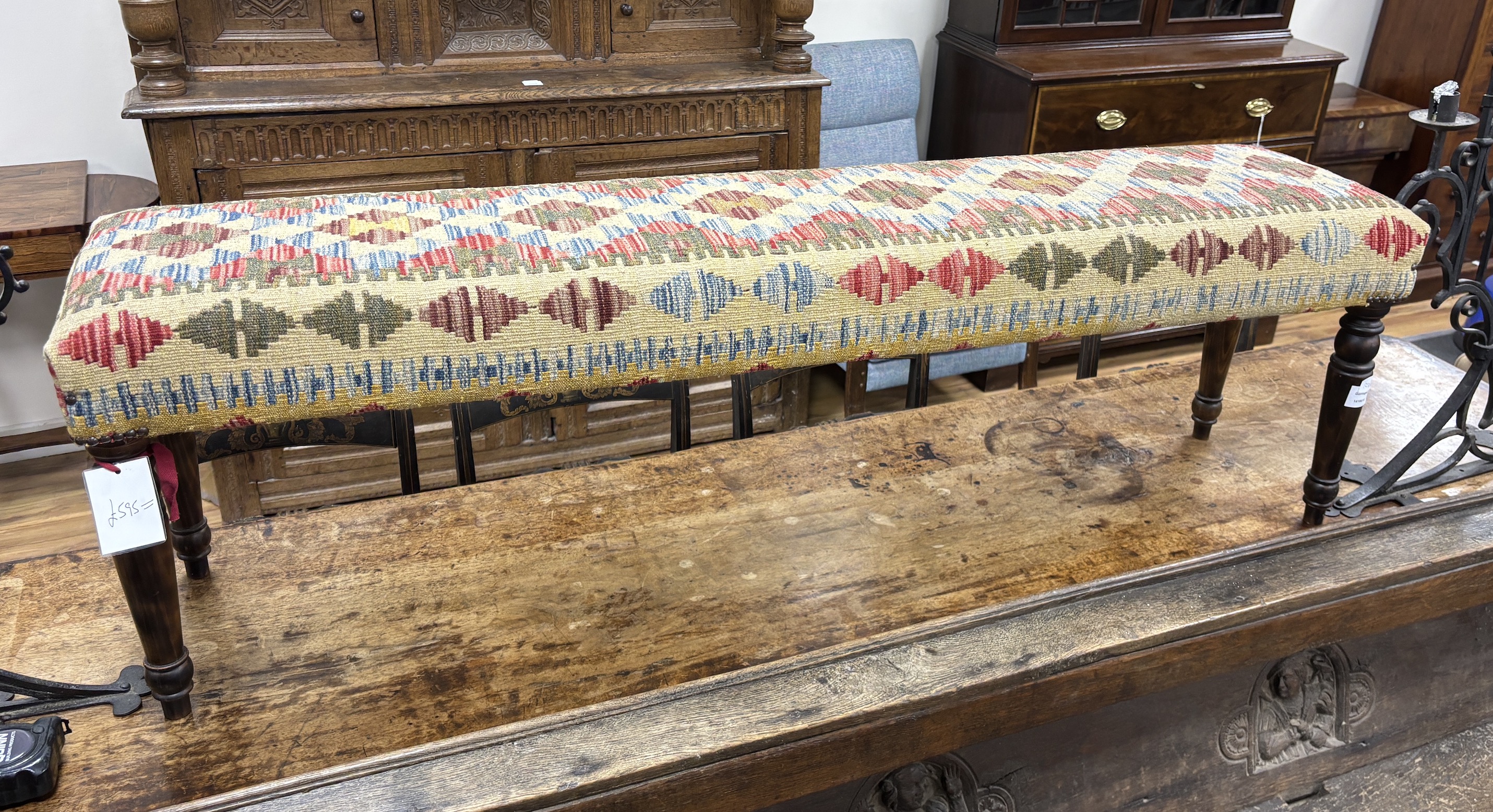 A Kilim covered long stool on turned beech legs, width 153cm, depth 34cm, height 47cm